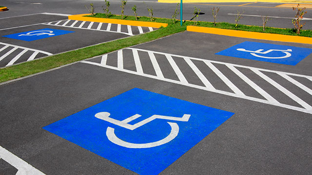 Handicap parking space. Parking lot inaugurated recently. Universal symbols painted on the asphalt.
